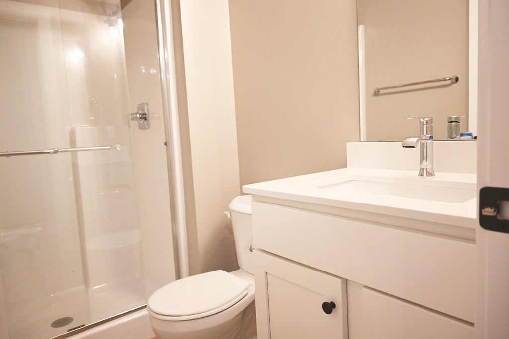 A white toilet sits next to a sink in a bathroom.