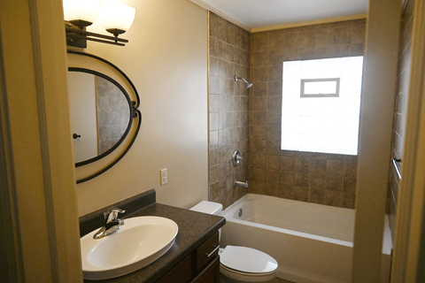 A bathroom with a sink, toilet and bathtub.