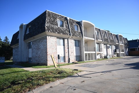 A row of apartment buildings with a clear blue sky above.