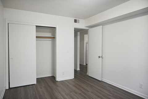 A white door is open to a hallway.