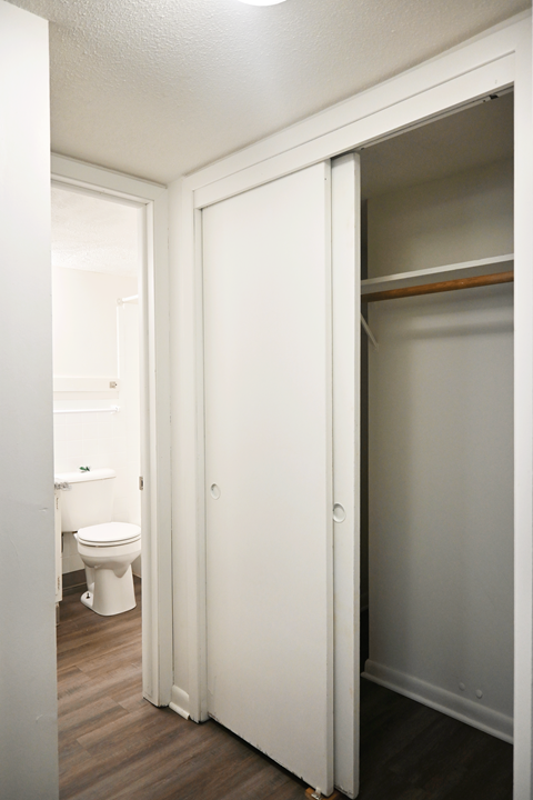 A white bathroom with a toilet and a white door.