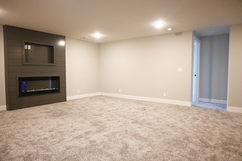A living room with a fireplace and a flat screen TV.