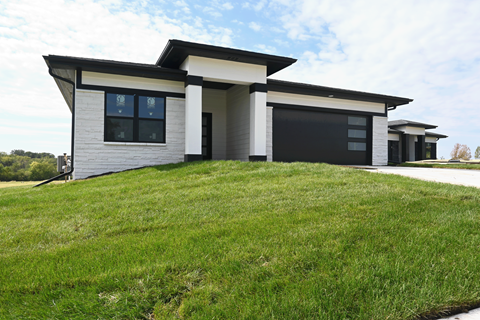 A modern house with a black garage door.