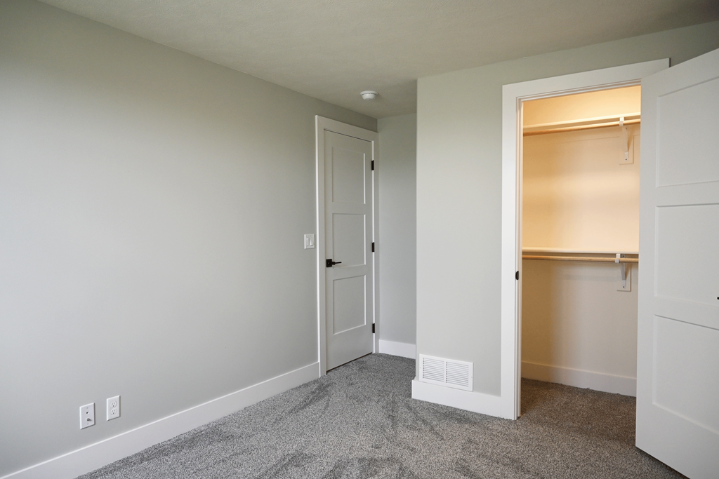 A room with a white door and a window.