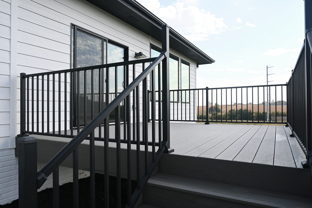 A black metal railing on a wooden deck.