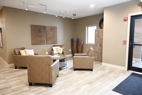A living room with a brown couch and a coffee table.