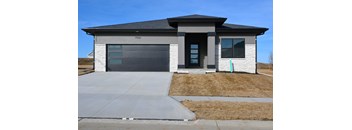 Front exterior view of a single family home with modern facade, attached garage and concrete driveway at 11918 S 117th Street.