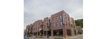 Exterior view of a multi story residential building for the 2 Bedroom 2 Bath Row Home at The Sawyer.