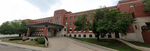A red brick building with a covered walkway.