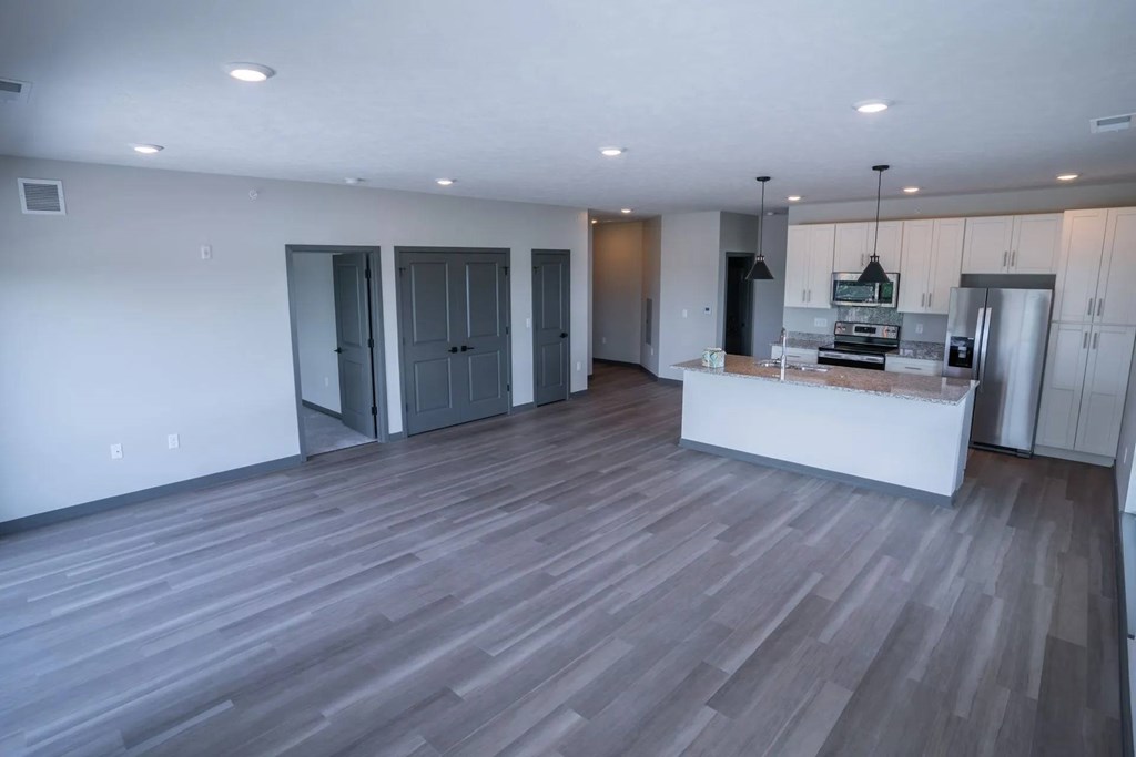 A kitchen with a white counter and a refrigerator.