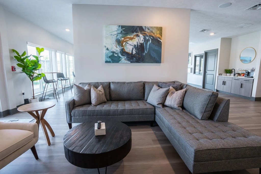 A grey couch with a coffee table in front of it.