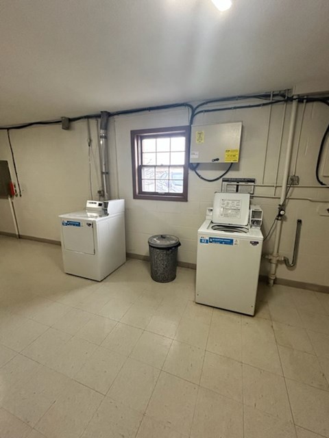 A room with two white machines and a window.