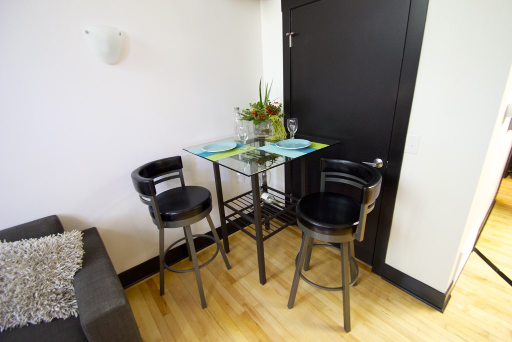 A black chair sits in front of a black door.
