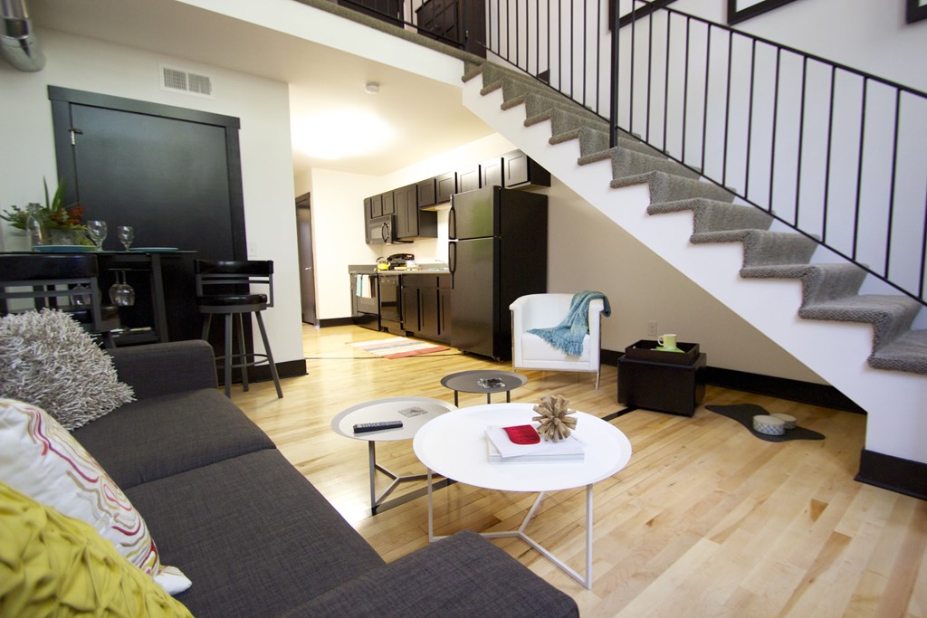A living room with a grey couch and a white coffee table.