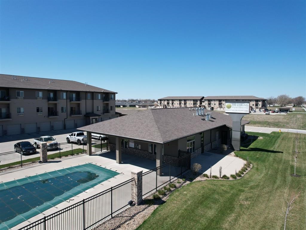 A large building with a pool in front.