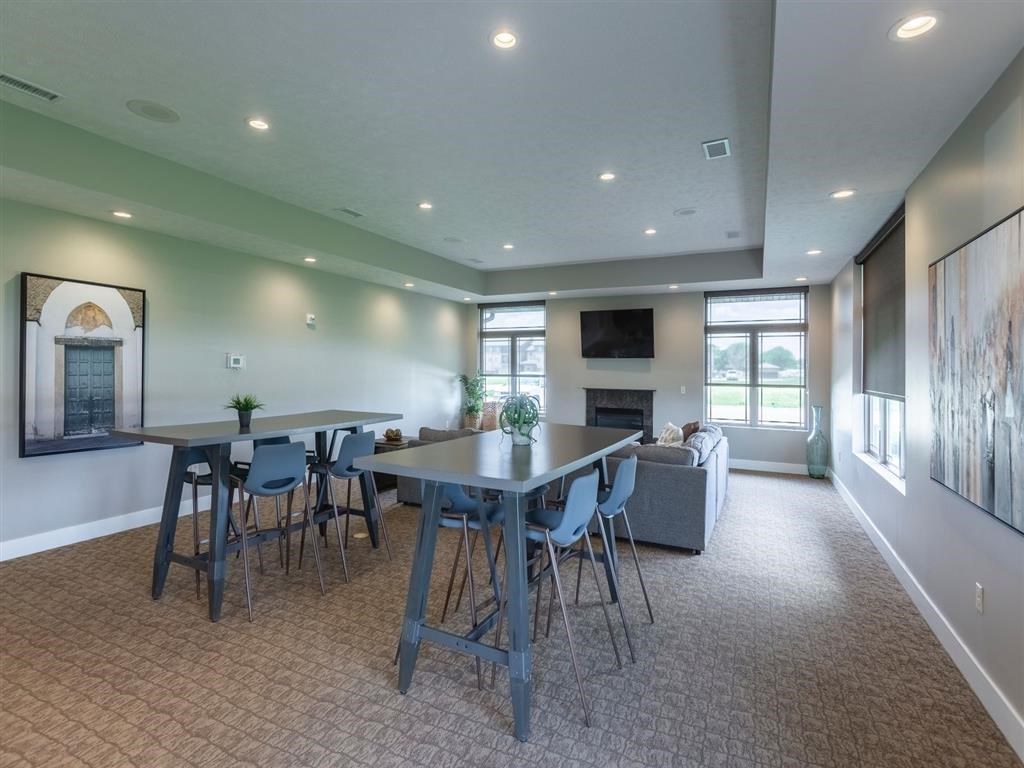 A dining room with a table and chairs.