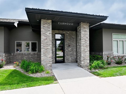 The clubhouse has a glass door and is made of brick.