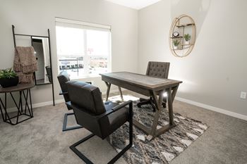 A room with a table and chairs in it.