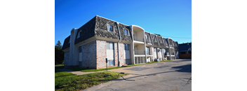 Exterior view of a multi story apartment building with brick and siding at Northbrook Apartments