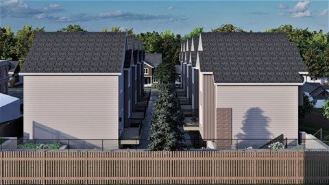 A modern house with a grey roof and a brown fence.