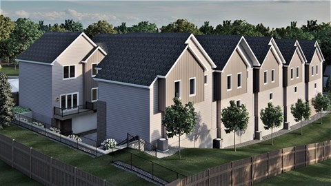 A row of houses with a fence in front.