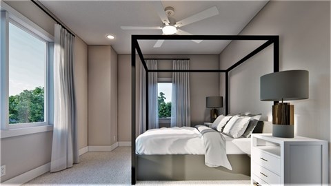 A bedroom with a bed, nightstand, and window.