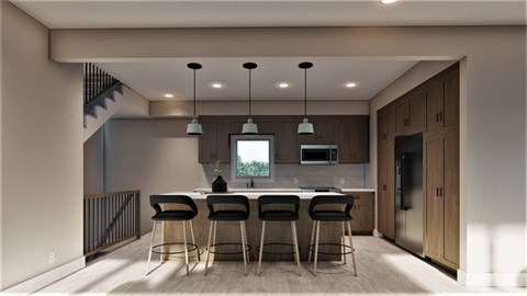 A modern kitchen with a bar area and a staircase.