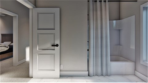 A white door is in a room with a bed and a window.