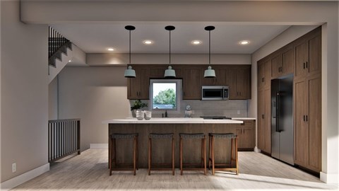 A modern kitchen with a bar area and a staircase.