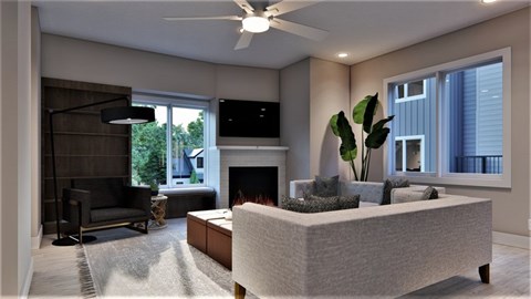A modern living room with a fireplace and a grey sofa.