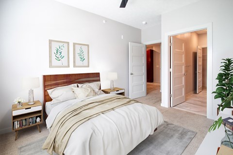 A bedroom with a large bed and a ceiling fan.