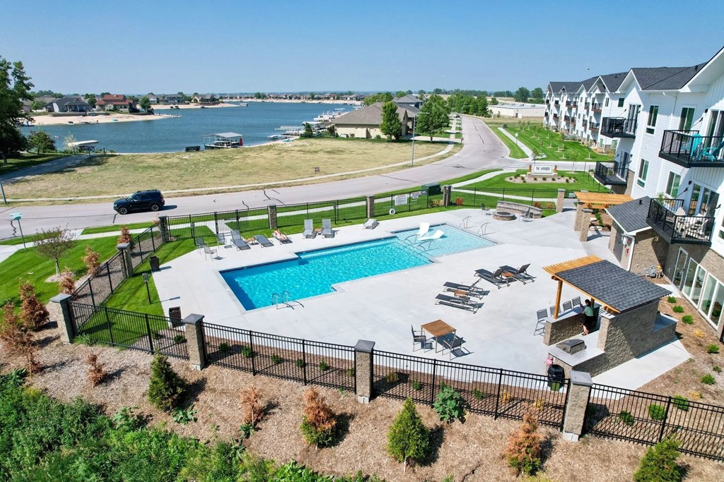 A large backyard with a pool and a deck.