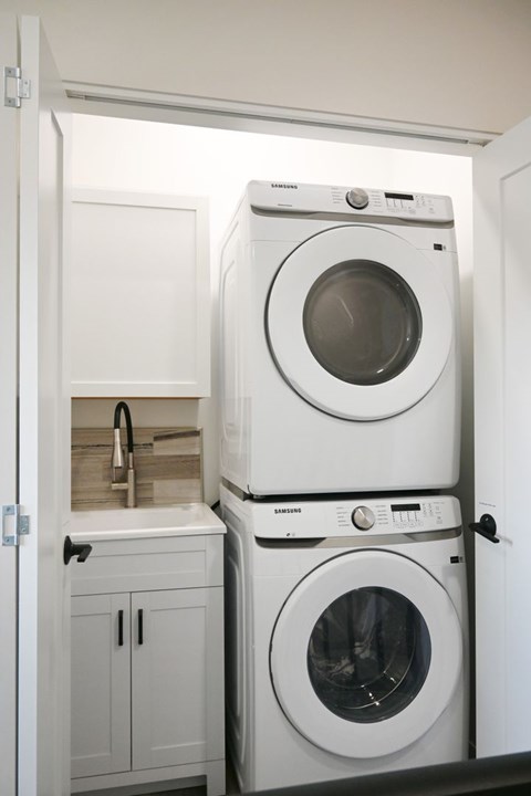 A white washing machine and dryer in a small laundry room.