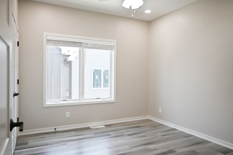 A room with a window and a door.