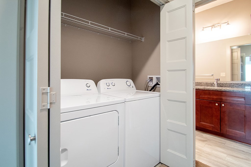 A white washer and dryer in a laundry room.
