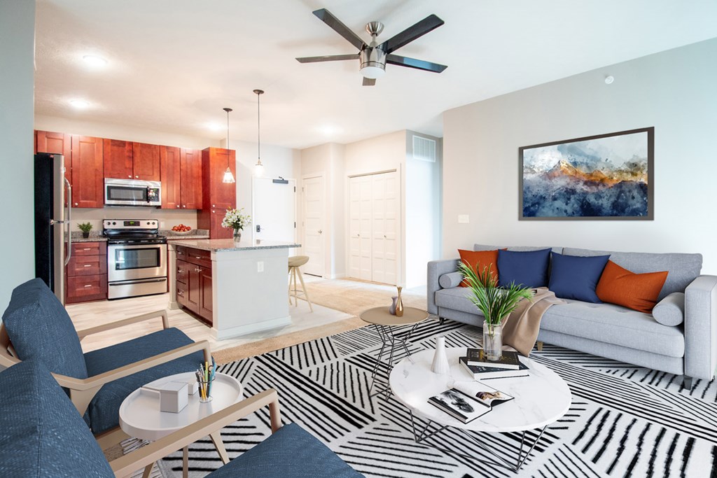 A modern living room with a black and white striped rug on the floor.