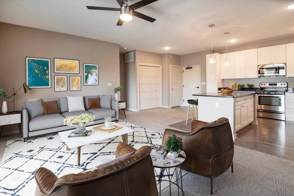 A living room with a brown leather chair and a white coffee table.