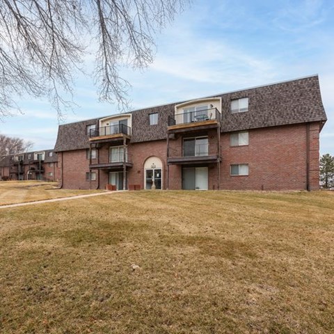 A large brick building with a balcony on the second floor.