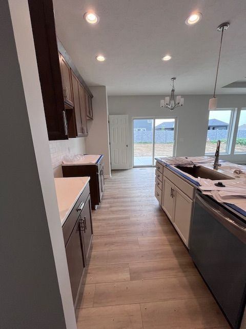 A kitchen with wooden floors and a large island.