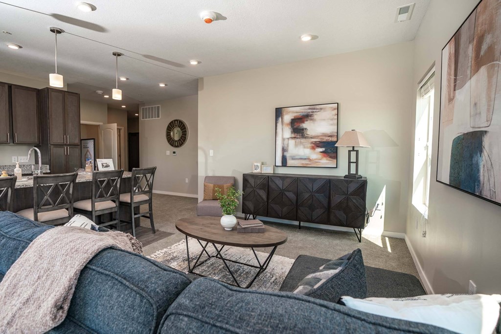 A living room with a grey couch and a coffee table.