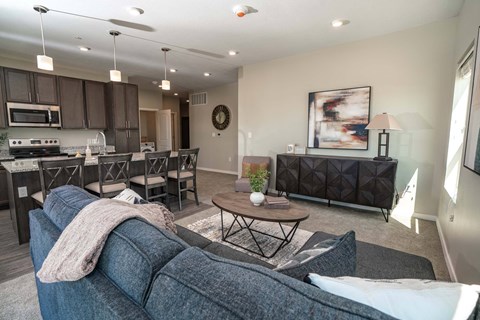 A living room with a grey couch and a coffee table.