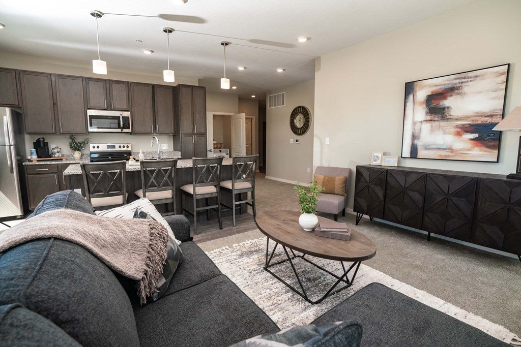 A modern living room with a grey couch and a coffee table.
