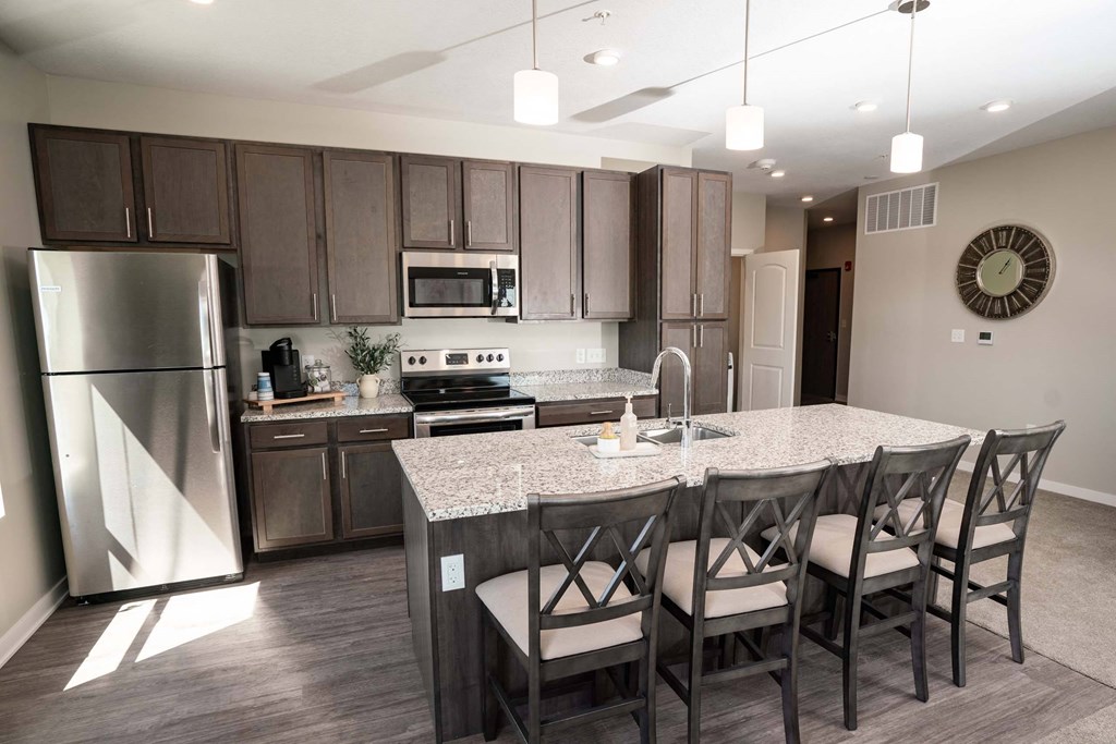 A kitchen with a table and chairs.