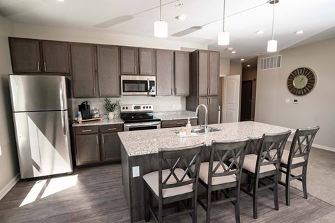 A kitchen with a table and chairs.