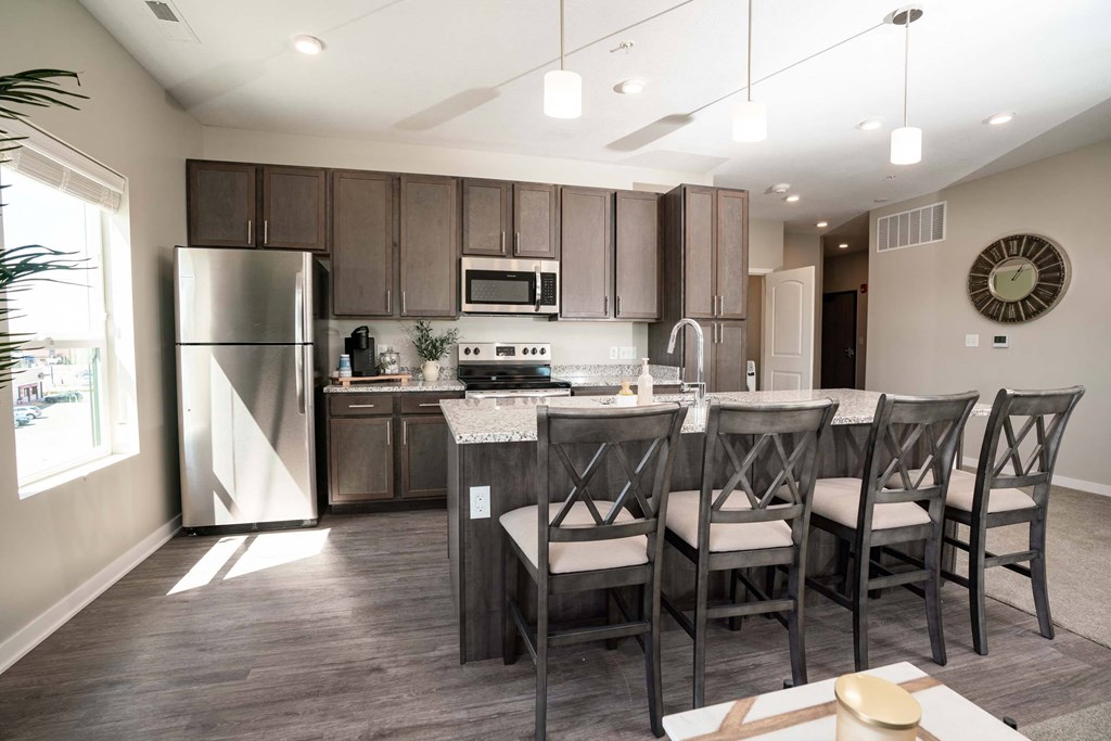 A modern kitchen with a dining table and chairs.
