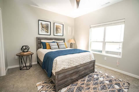 A bedroom with a large bed and a window.