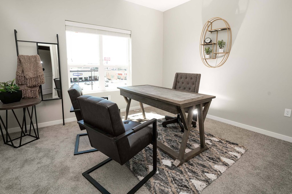 A room with a table and chairs and a mirror on the wall.