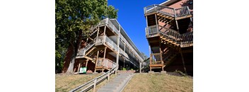Exterior view of a multi level apartment building with exterior staircases at Cuming St Apartments.