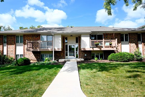 A building with a white walkway in front of it.