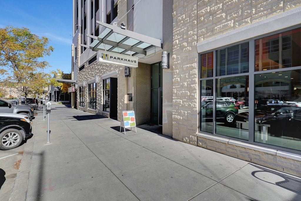 a street view of a building with a parking meter on the sidewalk at Parkhaus Apartments, Lincoln, Nebraska